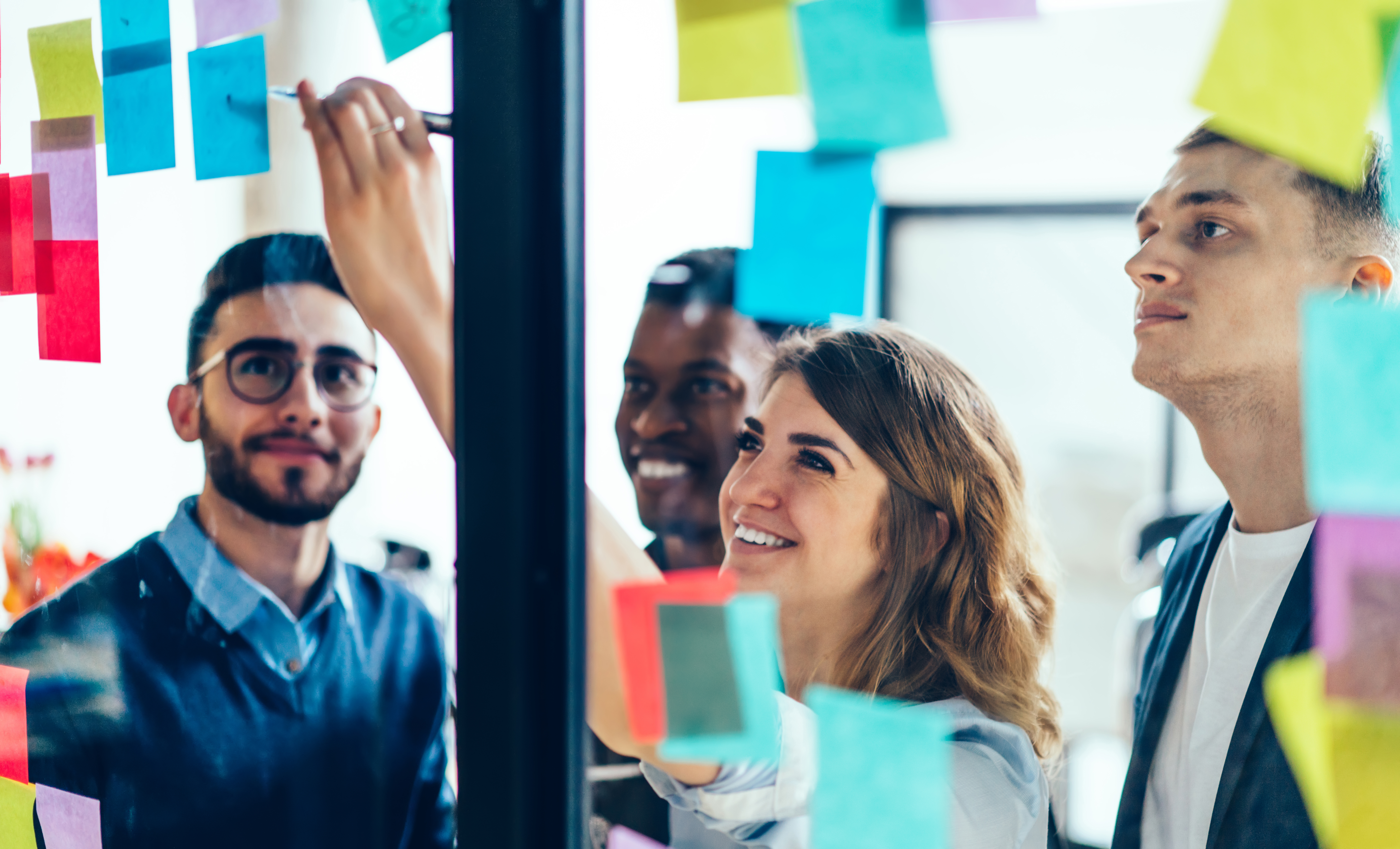 Team writing on sticky notes